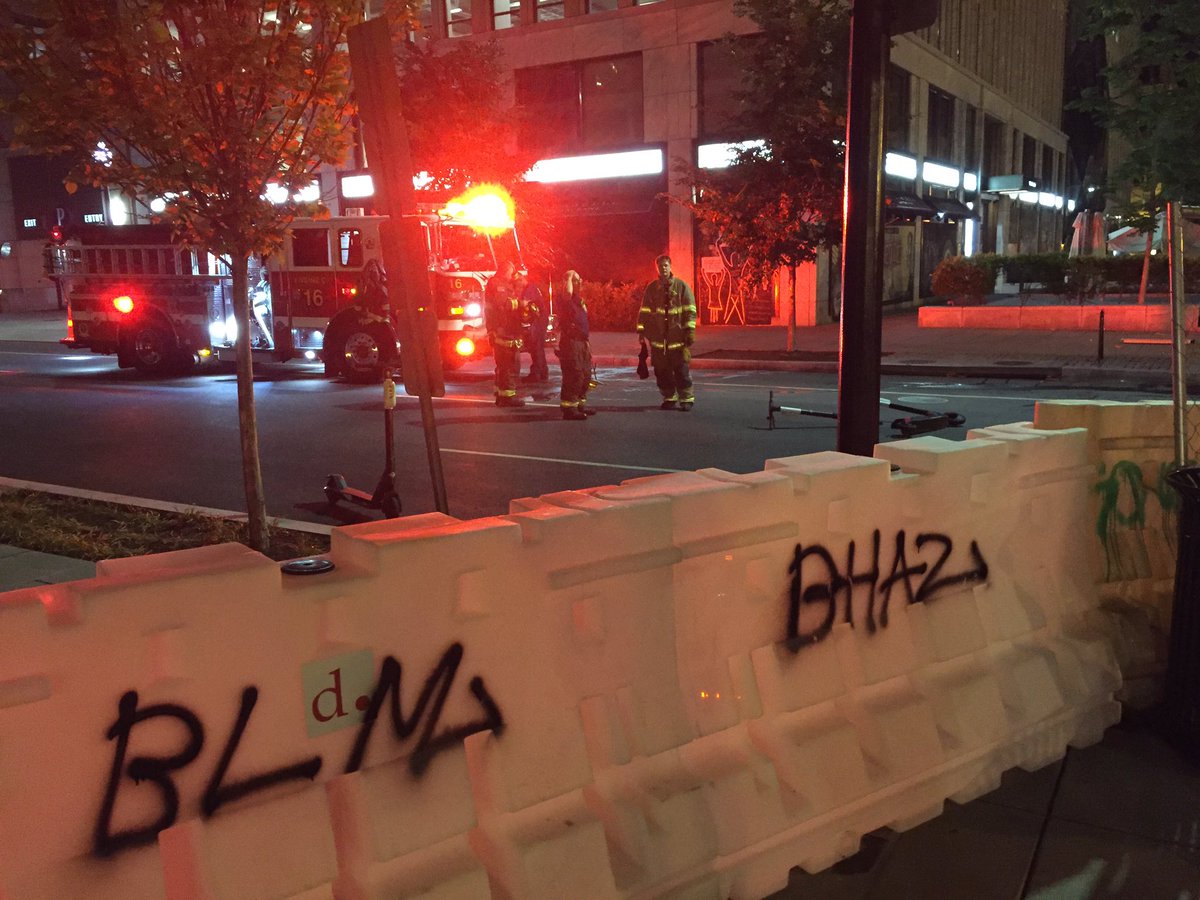 Down on 16th and I, a barrier put up by protesters. Fire department showed up because there was a fire in one of the dumpsters blocking the street. More barricades labeled BHAZ, too.