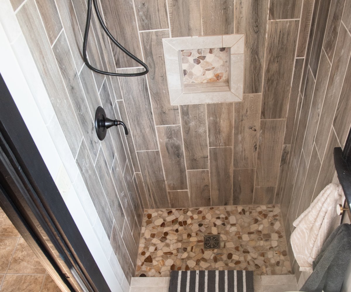 We love the look of the natural stone in our newly remodeled walk-in shower! 
#home #bathrooms #homeimprovement #tiling #builder #paintedcabinets  #luxury #homeremodel #bathroomrenovations #decor #interiordesigner  #interiors #tileshower #modernbathroom #bathroomremodeling