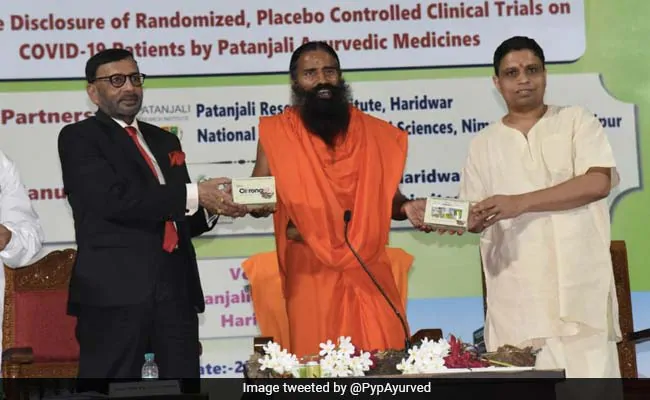 The suited man is Dr. Balvir Singh Tomar, Chairman of National Institute of Medical Sciences,Jaipur where  #Patanjali conducted 'clinical control study'. He was arrested in 2016 for attempt to rape his student. His son Dr.Anurag Tomar, a trustee, was accused of raping an employee.