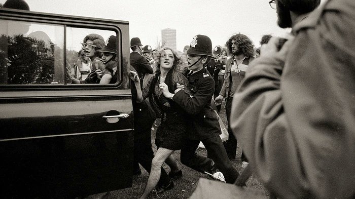 1971: The GLF interrupt British Christian Nationwide Festival of Light, whose agenda included homophobia, with a series of demonstrations. Lesbian activists invaded the platform of the Women's Liberation Conference demanding recognition. (Image: GLF members arrested in 1971)