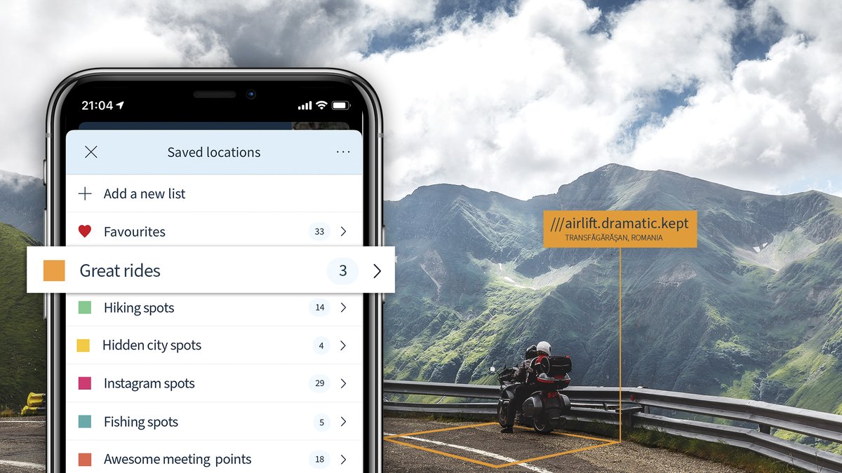 Saved locations list colour coded according to different types of location. Mountainous backdrop with what3words address reading ///airlift.dramatic.kept