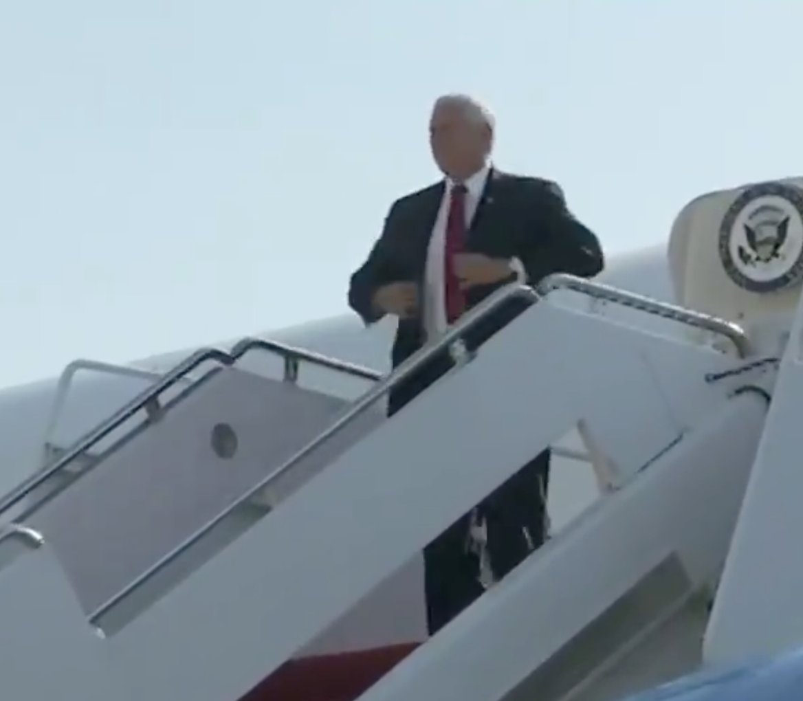 5/ He immediately stands up, spins counter-clockwise as he orients with his back away from the plane (and facing toward a presumed audience/cameras), and then straightens his suit jacket with both hands.