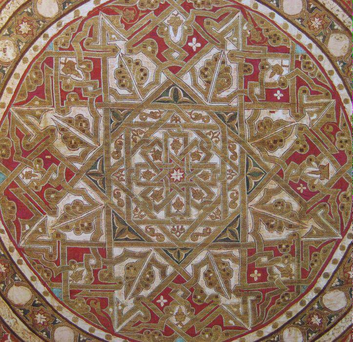 I'd read in various places, including al-Qantara ( https://www.qantara-med.org/public/show_document.php?do_id=222&lang=en#) that there was an inscription in the central medallion that read al-mulk, sovereignty. Today I realized the whole big 8 pointed star at the center is made up of the calligraphy of that word, repeated.