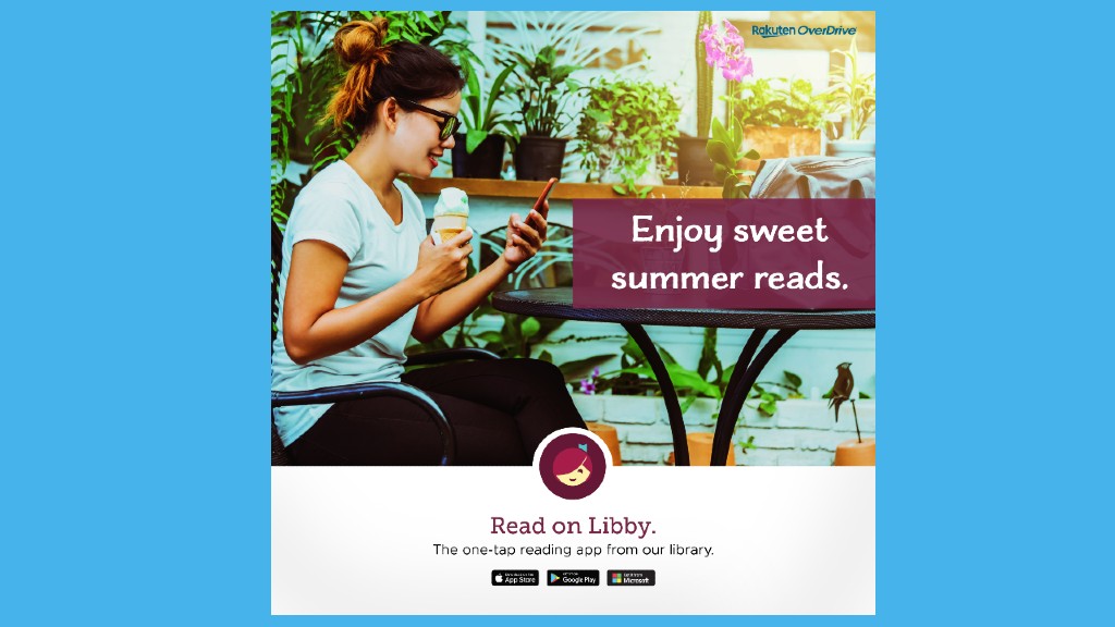 a woman sitting down at an outide cafe readin her smartphone with an ice cream cone in the other hand
