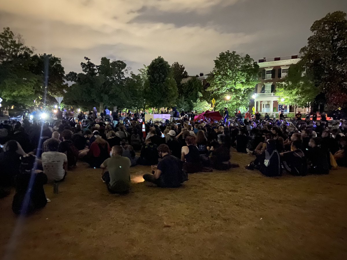 speakers are addressing a seated crowd. he reminds us that cops are staging not far from here, probably giving speeches of their own. “we over here chillin’, we’re cookin’ chicken!” says one speaker. “we’re winning right now.”