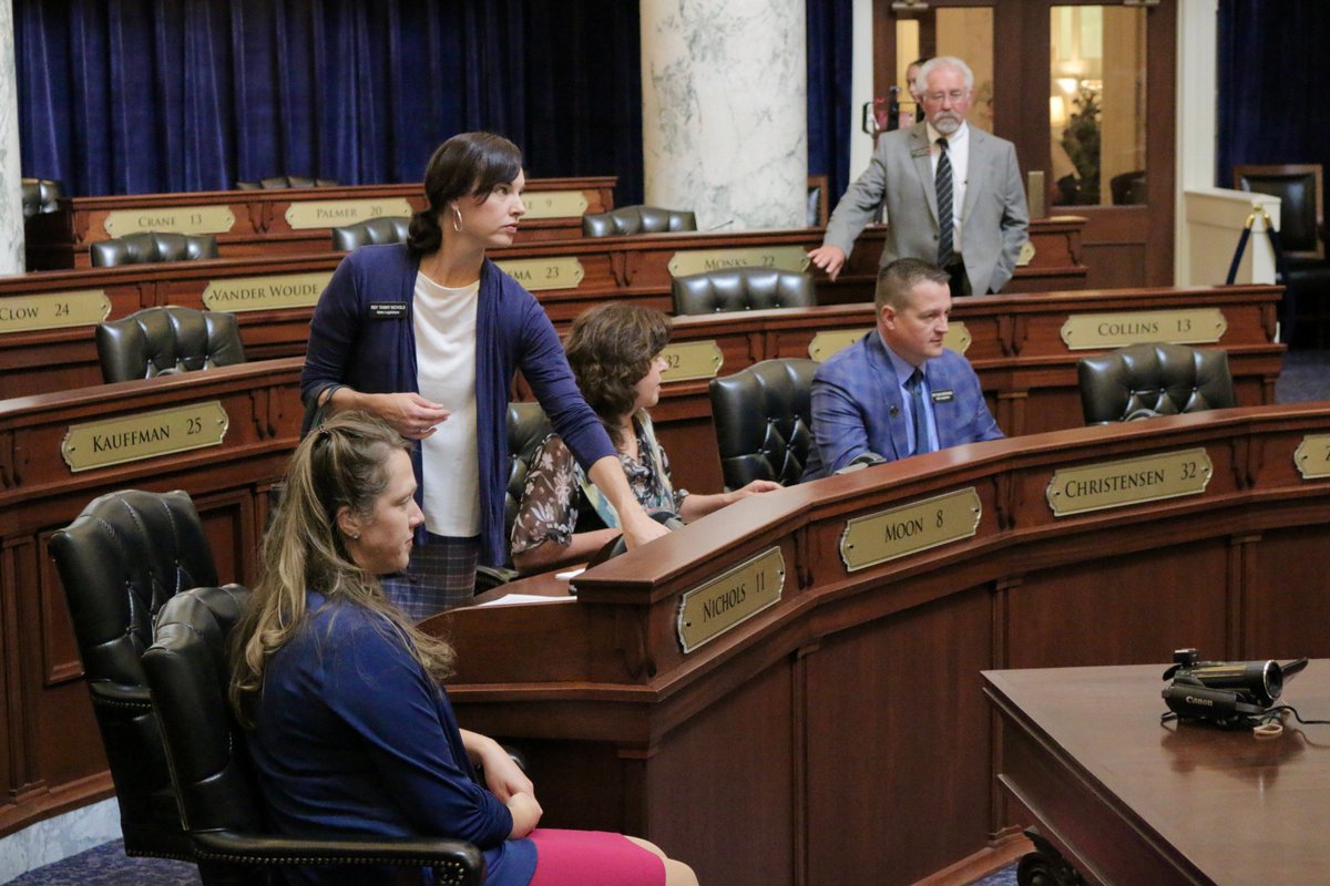Lawmakers re-entering the chamber after going out into the hallway, gathering chairs to sit in the well.