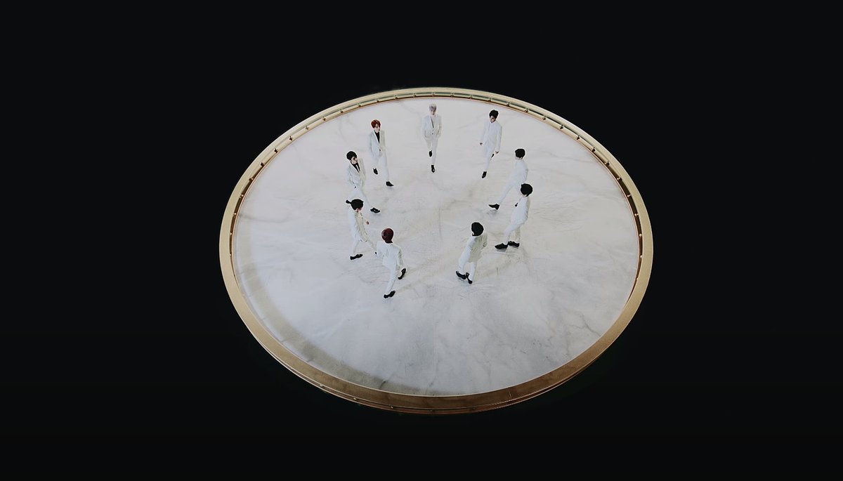 It ends with them, now together, in the circular platform moving to the center in sync with each other. The giant looping bracelets encircles them like a globe. Norse version of the Ouroboros myth; snake encircling the world. Hindu version, foundation of the Earth.