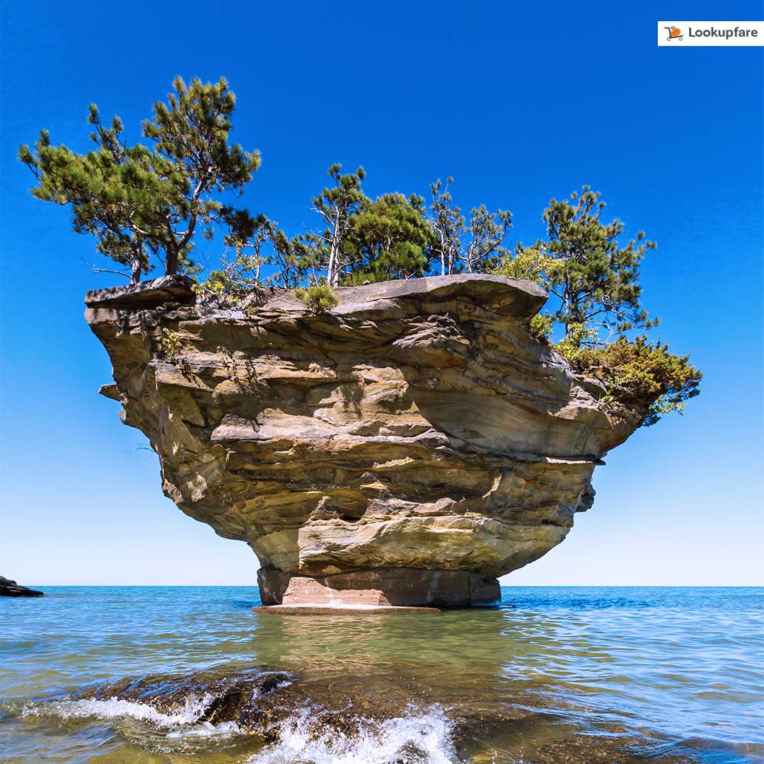lookupfare's tweet photo. Located just west of the tip of Michigan’s thumb on Lake Huron, Port Austin’s Turnip Rock is so remote, it can be reached only by kayaks. #Michigan https://t.co/mbDTV1fgPm