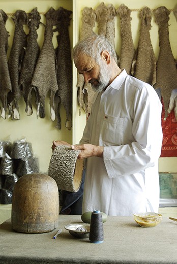 People of  #Kabul: Local hatter crafts the traditional Qaraqul hat, made from the fur of a local breed of sheep.Picture from "WorldNomads".
