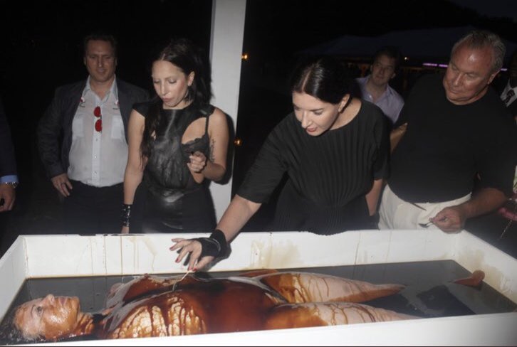 PART 24: Marina Abramovic She is a “performance artist” and as you can see she is friends with quite a few celebs. And her choice of art? Depictions of cannibalism and “spirit cooking”. She is 73 yrs old