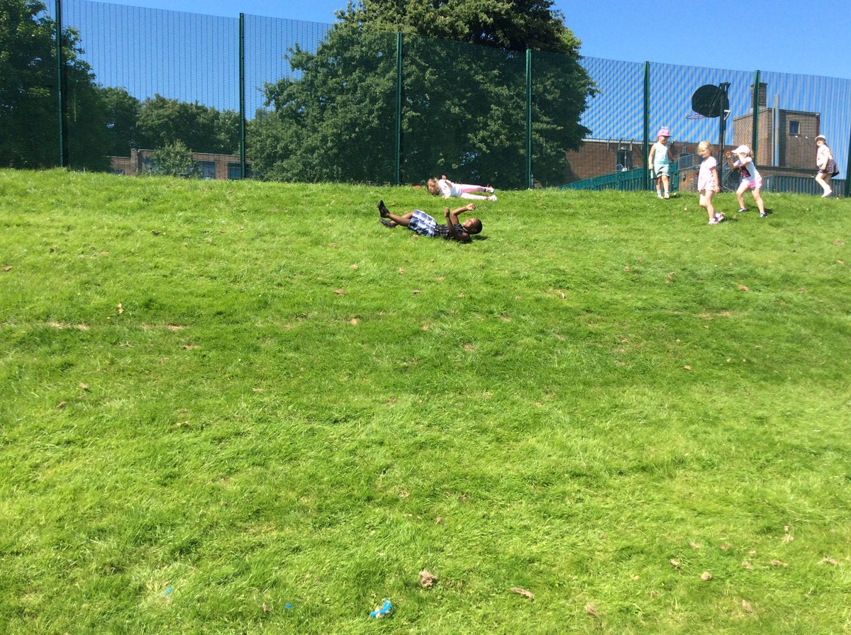 Stradbroke_Y1's tweet photo. ☀️ FUN IN THE SUN ☀️ Year 1 had lots of fun rolling down the hill on the school field this morning! #SocialDistancing #OutdoorPlay #JustKeepRolling @StradbrokePri https://t.co/Zm45VLMPyy