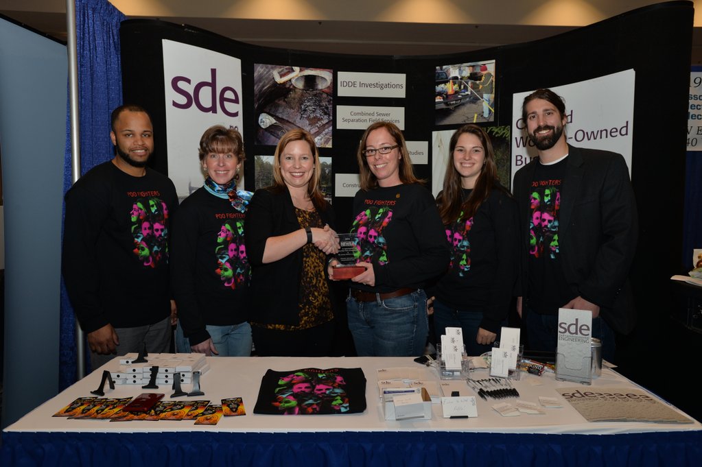 sde_inc's tweet photo. #TBT SDE receiving an award at NEWEA... in the days of the Poo Fighters. Yes, reference is to the Foo Fighters and @GarrettBergey as David Grohl. https://t.co/3CDh6fZKh0