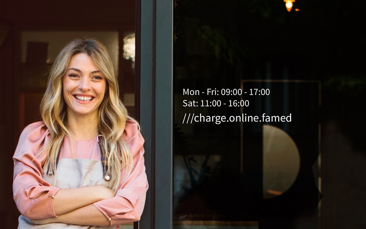 woman standing outside shop addressed ///change.online.famed