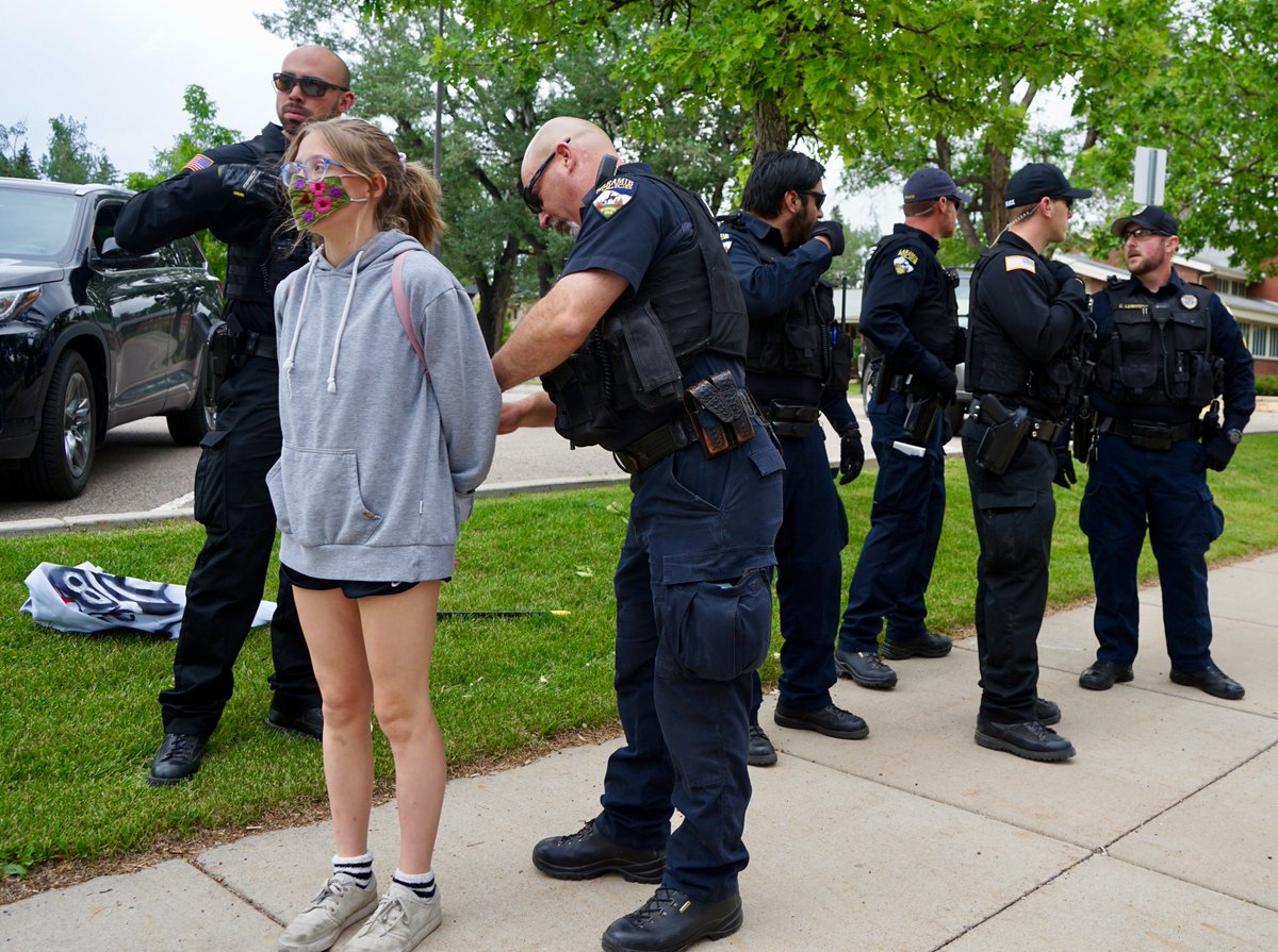 Laramie police arrest a young protester during tonight's march. 