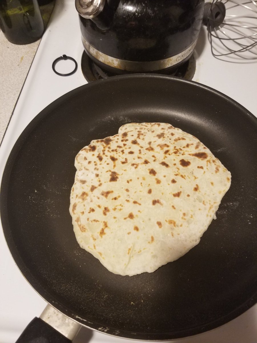 Cook on a dry pan (do not oil it!) on a medium setting (I use 7 on the dial) til it puffs up a bit and develops spots. The lefse's round with spots of brown *clapclapclapclap* Oh yeah, you betcha, uff da! Flip and cook til the other side is spotty.