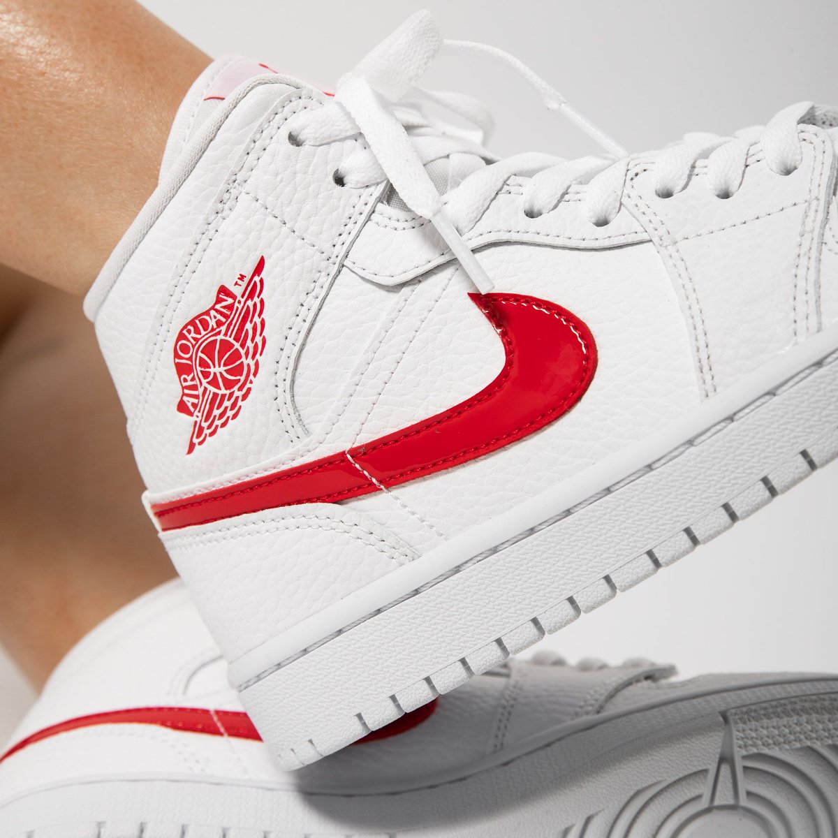 white jordan 1 with red tick