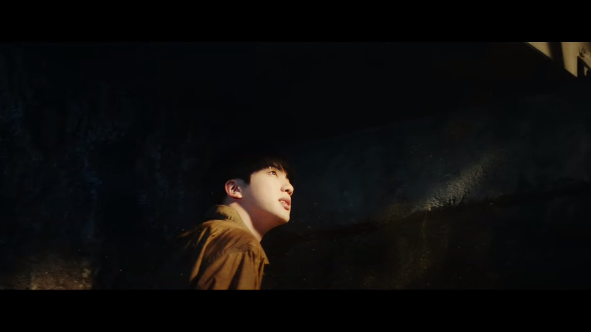 Back to the grey world. Have you noticed that the gold specks come from above? They all lift up their heads. The only way is to go up, to rise. And this is what Jin does going up the stairs.Remember ON mv, going up the mountain? @BTS_twt