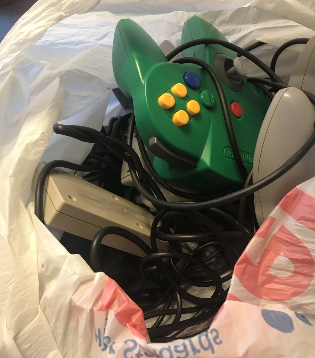 Of course I live for this kinda of moment. We ripped the tape off the top and my neighbor pulled out a bag of controllers and wires, then a dusty N64 and NES. But the box was far from empty!