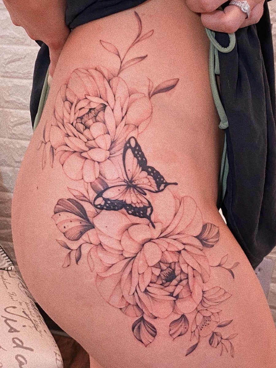 Butterfly tattoo done in fine line on the hip