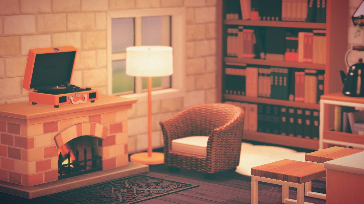 A living room in Animal Crossing: New Horizons. It features a fireplace, a rattan armchair, a floor lamp, a bookshelf, and a record player.