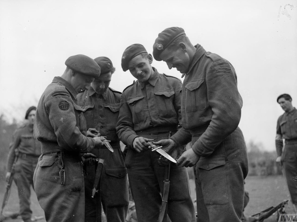 This photo taken in Germany '45, features men of 45 RM Commando. Note the chap on the left with the curved flash and his missing 'Commando' tape and the chap on the right with the earlier straight flash. Not sure when the change was made between the two (not an expert alas)!