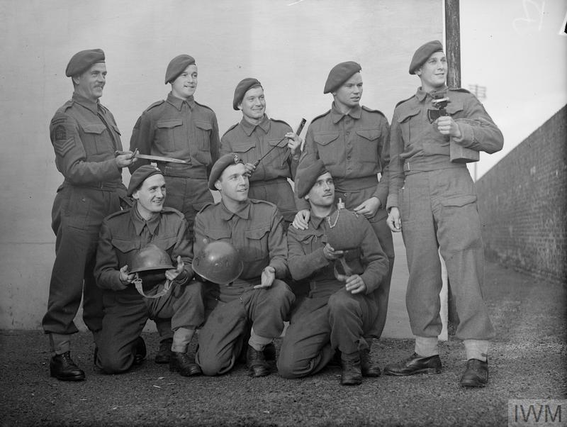 Another good photo of RM Commandos who fought at Salerno posing with souvenirs back at Deal. Note the chap on the end with the flash which inspire the new, non-curved, patch.Source -  https://www.iwm.org.uk/collections/item/object/205153590