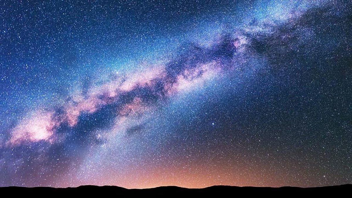 This had nothing to do with the name Milky Way.Our eyes can only see specific spectrum of light and colors. So to us the Milky Way to the naked eye looks mostly white in the sky. But it actually as A LOT more color then what we can see.