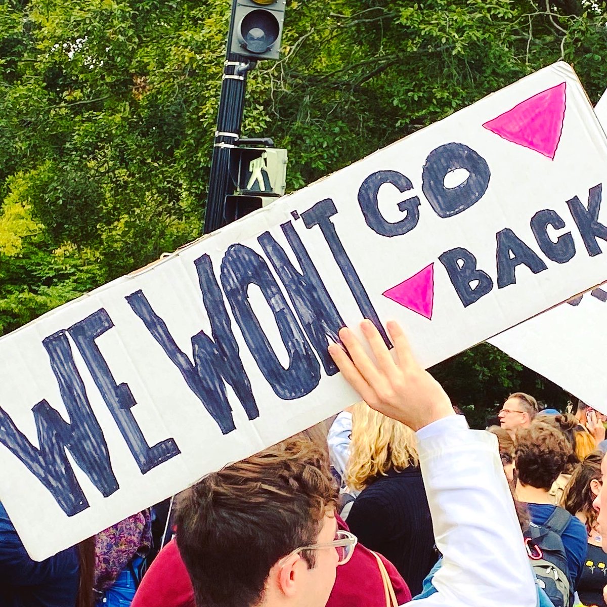 Protest sign reads: "We won't go back."