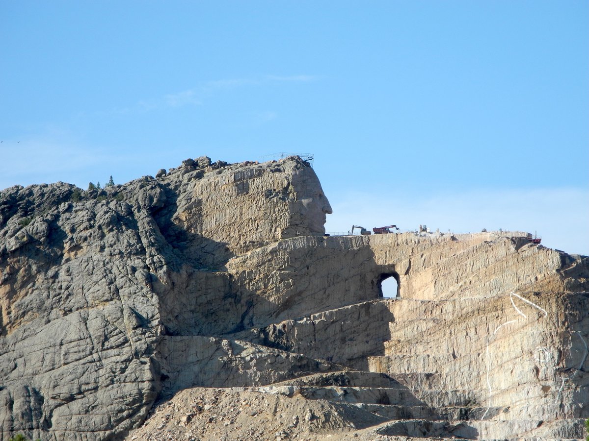 As an adjunct to Mount Rushmore, nearby is another remarkable monument, or at least the start of one. Another mountain is being sculpted into a statue of the Lakota Chief, Crazy Horse, who fought at the Battle of Little Bighorn. The second photo shows how it will look when done.