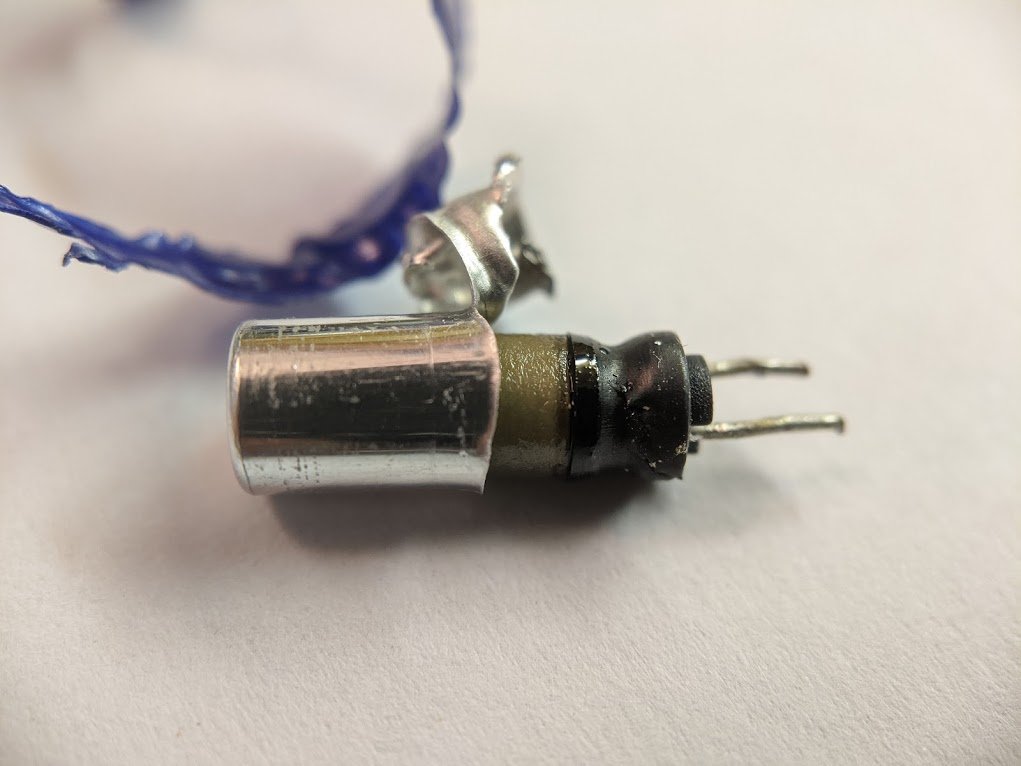 the aluminum case is crimped around this little rubber stopper which seals the capacitor.