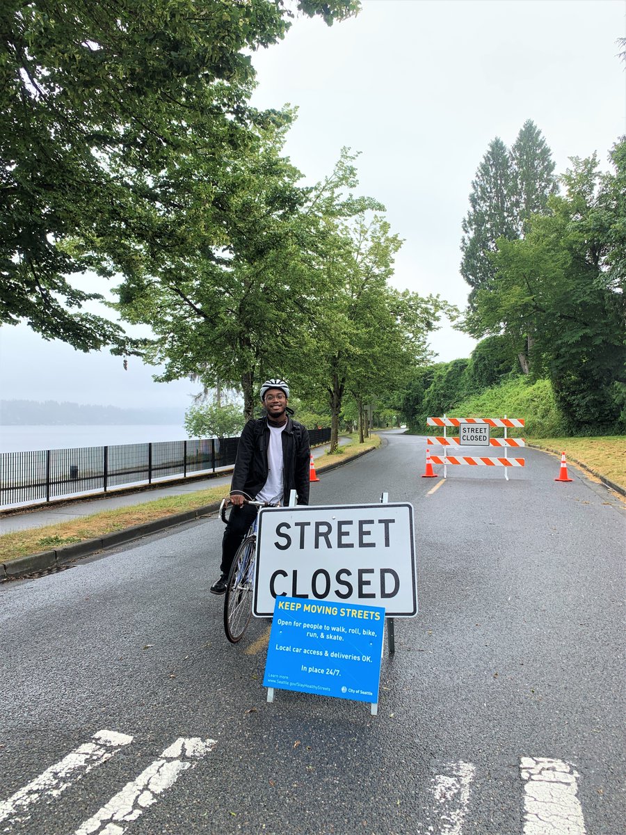 Ricky Reyes on his bicyle, paused on Lake Washington Blvd near the "Street Closed" sign marking the temporary street closure (to car traffic, that is -- but it's an OPEN street for walking, biking, skating, running, and rolling"