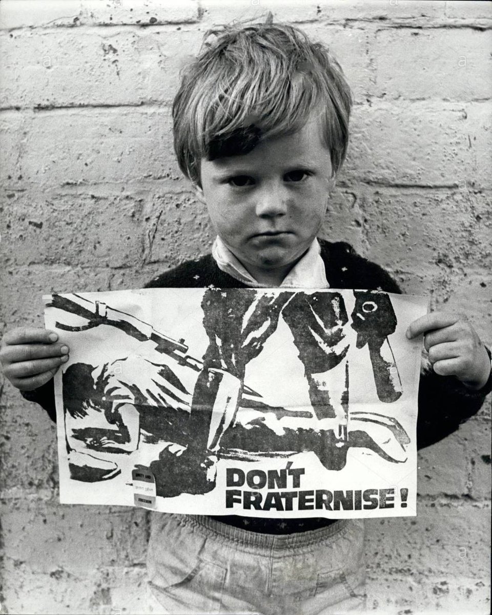 Boy in Belfast (1970) posing with Sinn Féin’s ‘Don’t Fraternise!’ poster.