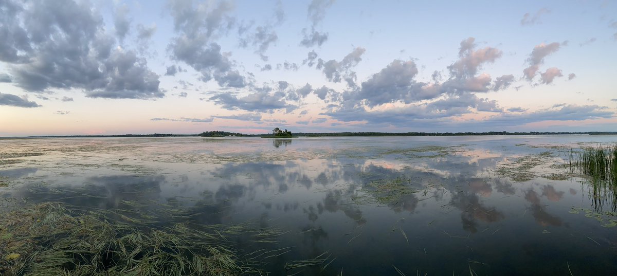 Sunset over Kawartha Lakes with clouds reflecting on the still water.