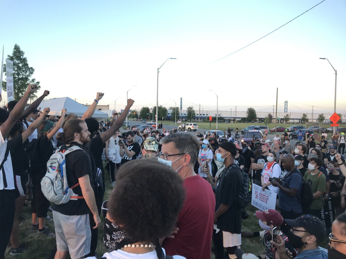 As the sun sets and the time approaches 9 pm, Detroit’s Monday protest march ends peaceably, and where it started on Fort Street a mile south of the Ambassador Bridge — on grass beside DPD’s 4th Precinct station — but with profane demands for Chief Craig to resign.