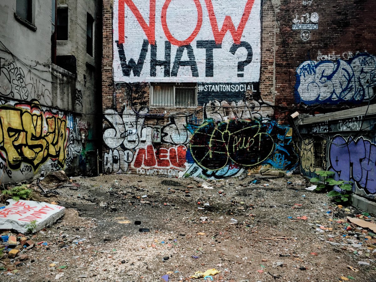 Abandoned lot covered in graffiti and dirty trash bits
