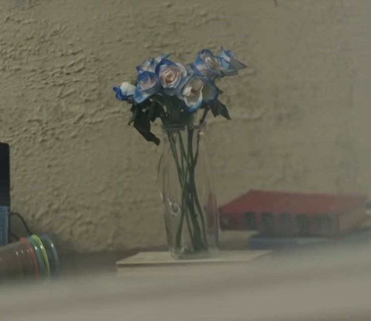 YG looks at himself in broken mirror and JK crushes a blue flower. This might be a reference to their argument in RUN kor. version.