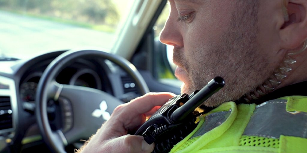 emergency responder speaks on walkie talkie