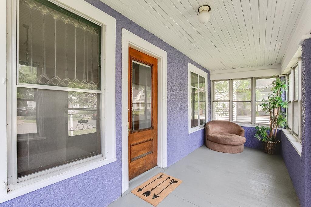 Tim: look at those beautiful old windows! Plus, a covered porch would be great for the kid to play outside, do crafts.Heather: I don't know about that purple though...