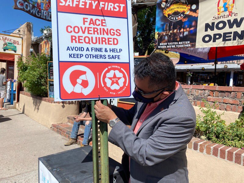 MayorWebber's tweet photo. You’ll be seeing these #SantaFePromise signs all over town reminding you that face coverings in public are mandatory in New Mexico and violators subject to a $50 fine. Mask up. Wash up. Keep your #socialdistance It’s how we show we care and respect each other. @CityofSantaFe https://t.co/H4TYU4wHMN