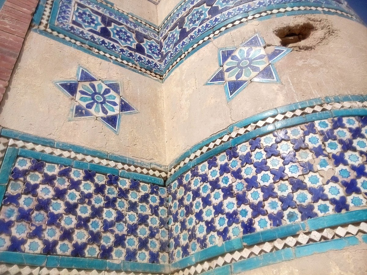 The tomb exterior is an elegant panorama of glazed tiles in different hues of blue & whiteSquare terra-cotta tiles painted in hues of Persian blue & whiteRectangular terra-cotta tiles with foliage design in high reliefTerra-cotta plugs cut in recess to join geometric patterns