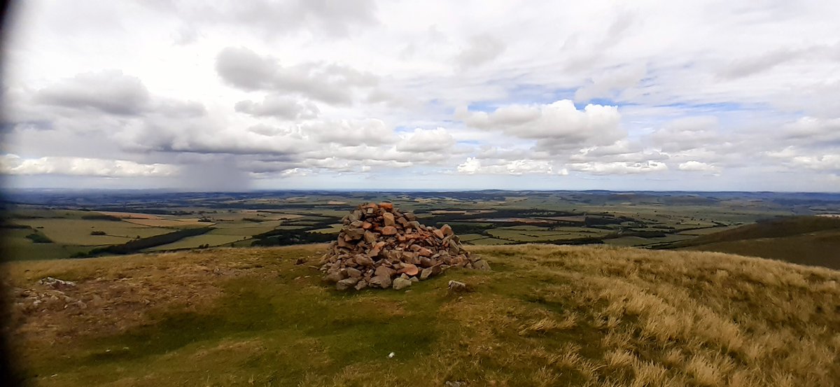 Day 2) cont:Below the twin-peaked, Yeavering Bell, I dropped my pack and sped up to the summit like a helium balloon cut from its tether. I admired the stone ramparts of the prehistoric hill fort. A cloud on the horizon resembled an atomic detonation as it dumped its load.