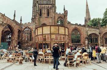 TheStage's tweet image. A pop-up venue initially created by architect @SebastianHick10 as an installation in the grounds of Coventry Cathedral is being offered for free to theatre companies looking to stage work outdoors bit.ly/3ewuO5M