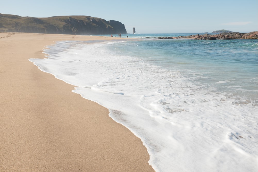 Often called the most beautiful beach in the UK, Sandwood Bay is a striking stretch of pink sand flanked by colossal cliffs and backed by the large dunes of Sandwood Loch. Unreachable by road, it’s also known as the most remote beach in the UK.