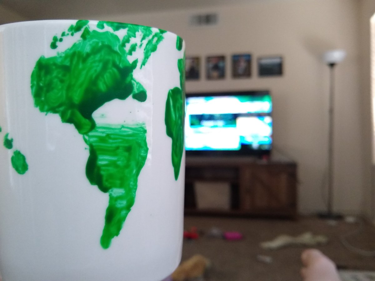 Watching #EsriUC2020 in my messy living room with my kids while drinking from a mappy mug hand painted by my 8yo son. 😊 🌍🌎🌏🗺️#esriuc