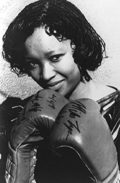 Zindzi Mandela, in 16 July 1988 in Soweto wearing the boxing gloves given to her father by the World Heavyweight Boxing Champion Mike Tyson as a present for his 70th birthday. (Photo credit should read -/AFP via Getty Images)