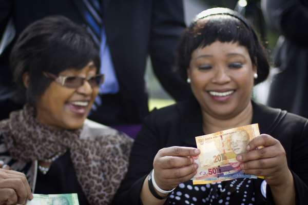 Winnie Madikizela-Mandela and her daughter Zindzi Mandela look at the new banknotes, which feature an image of former president Nelson Mandela on the front.