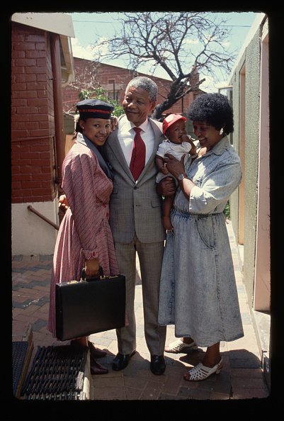 Nelson Mandela embraces his daughter Zindzi, his then wife Winnie and grandaughter after his release from prison. (Photo by Peter Turnley/Corbis/VCG via Getty Images)