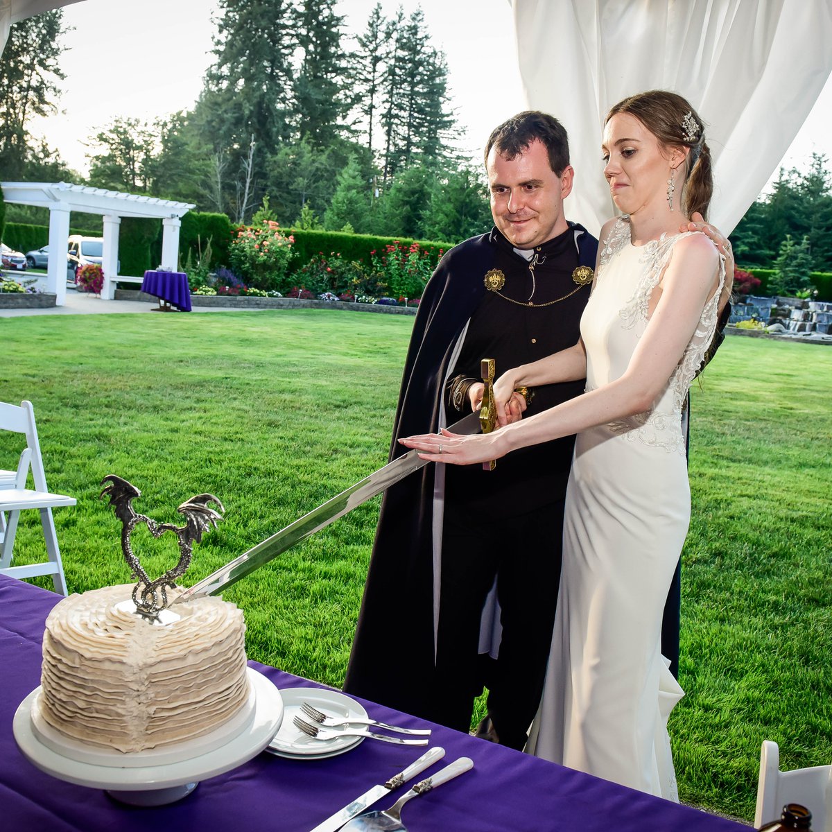 Cutting a cake together with a sword while Casey makes a profoundly dubious expression.