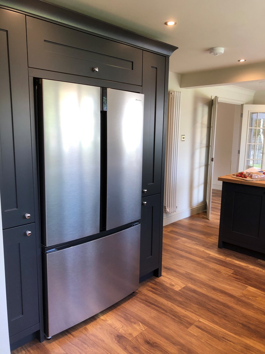 A very happy customer in our home town! This stunning kitchen with doors in graphite grey incorporates feature posts to add a freestanding effect to the furniture.  We teamed 40mm solid rustic oak worktops and finished with chrome cup handles and knobs to complete the look.
