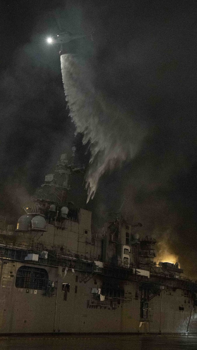 defpostmedia's tweet photo. A helicopter from #HSC3 combats a fire aboard #USNavy amphibious assault ship #USSBonhommeRichard (#LHD6) at @NavBaseSD, July 14. (USN Photo by MC3 Garrett LaBarge) https://t.co/ILjhxEmAZv